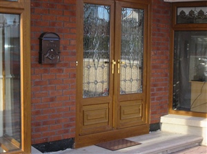 Golden oak French Double Door with a Bevel Design on the top half .